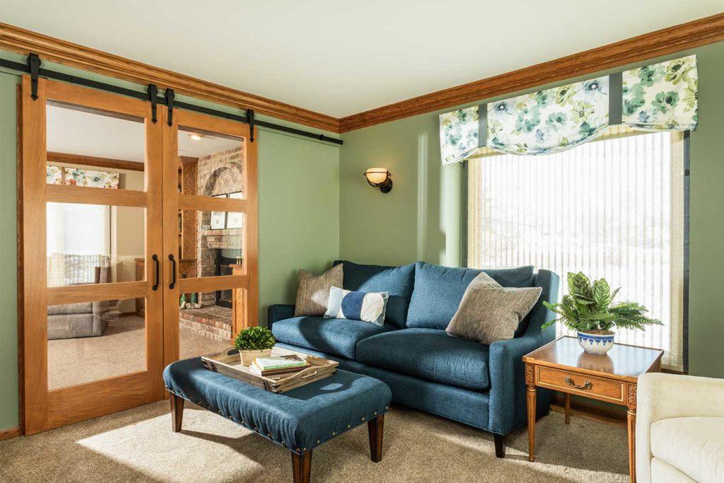 French doors were replaced with sliding doors to create a new media room. These doors block the noise but not the light without sacrificing the space for a door swing.